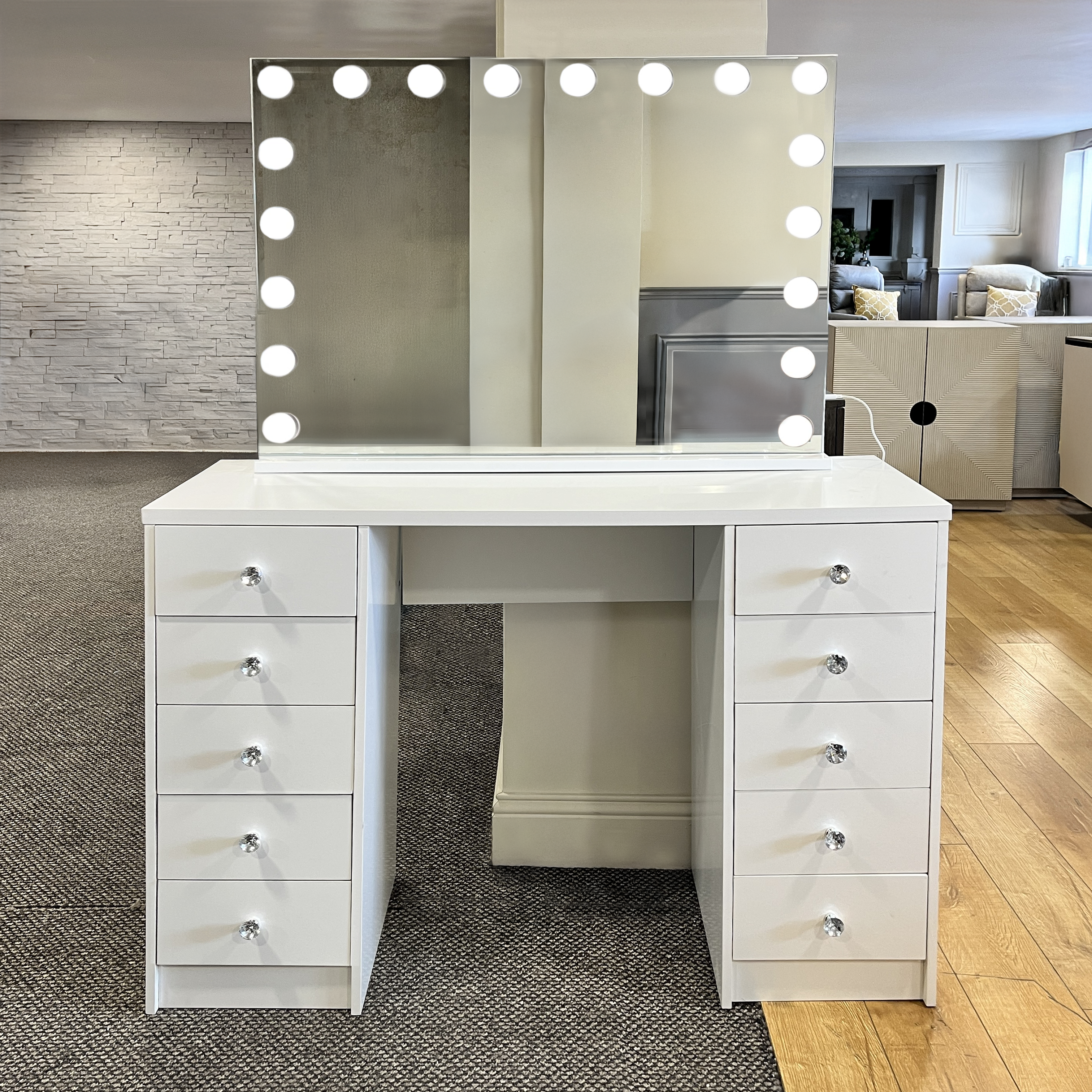 White vanity desk with illuminated mirror in a room setting