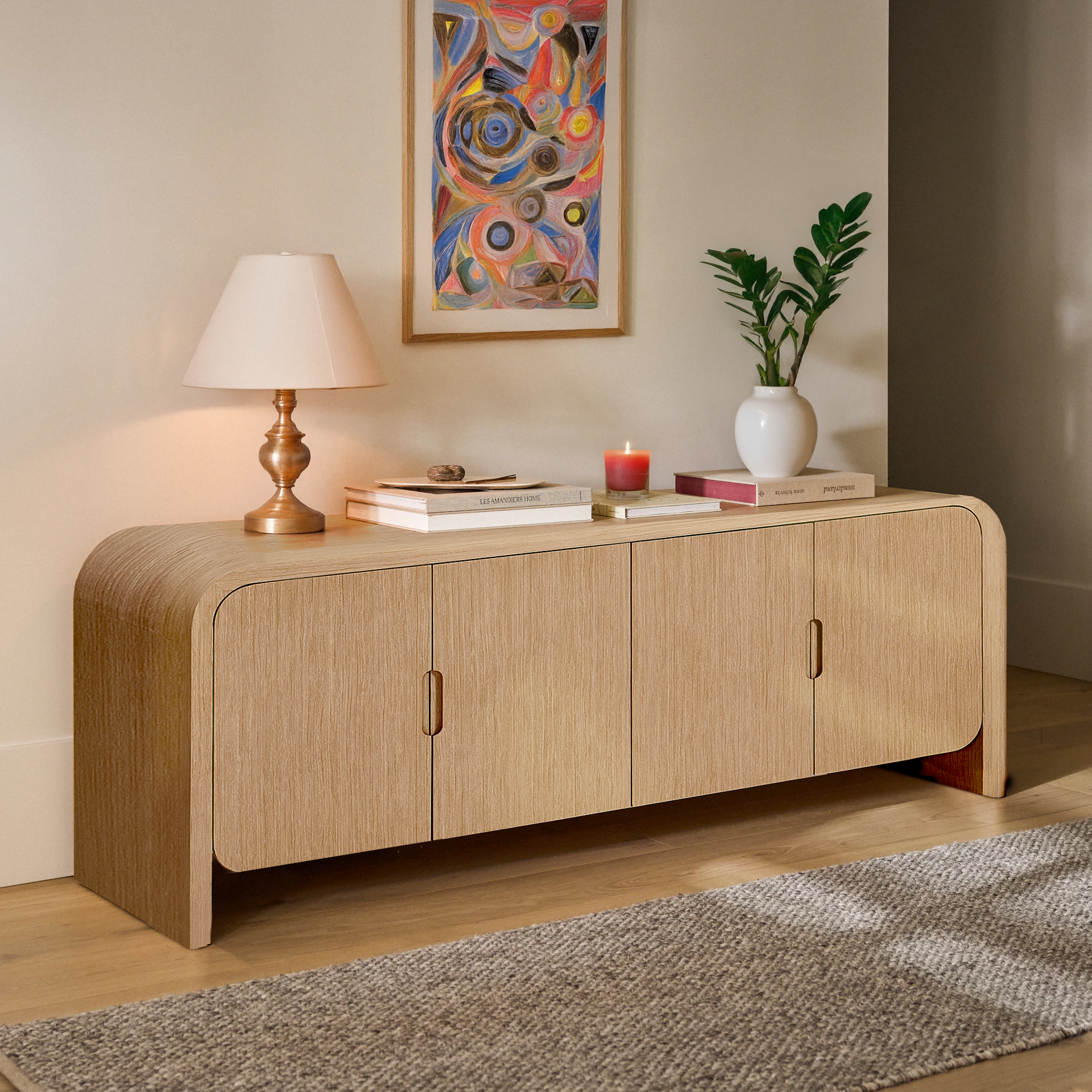 Wooden sideboard with decorative items in a room with a colorful abstract painting.
