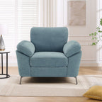 A teal upholstered Camden armchair with plush cushions and a contemporary design, placed in a living room setting.