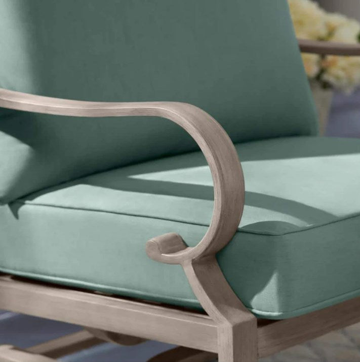 Chair with green cushions and wooden armrests on a blurred background