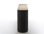 Black cylindrical lamp with textured white shade on a white background