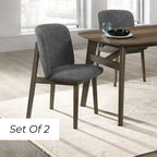 A set of two Alice Dining Chairs with a wenge finish and gray upholstered seats, placed around a wooden dining table.