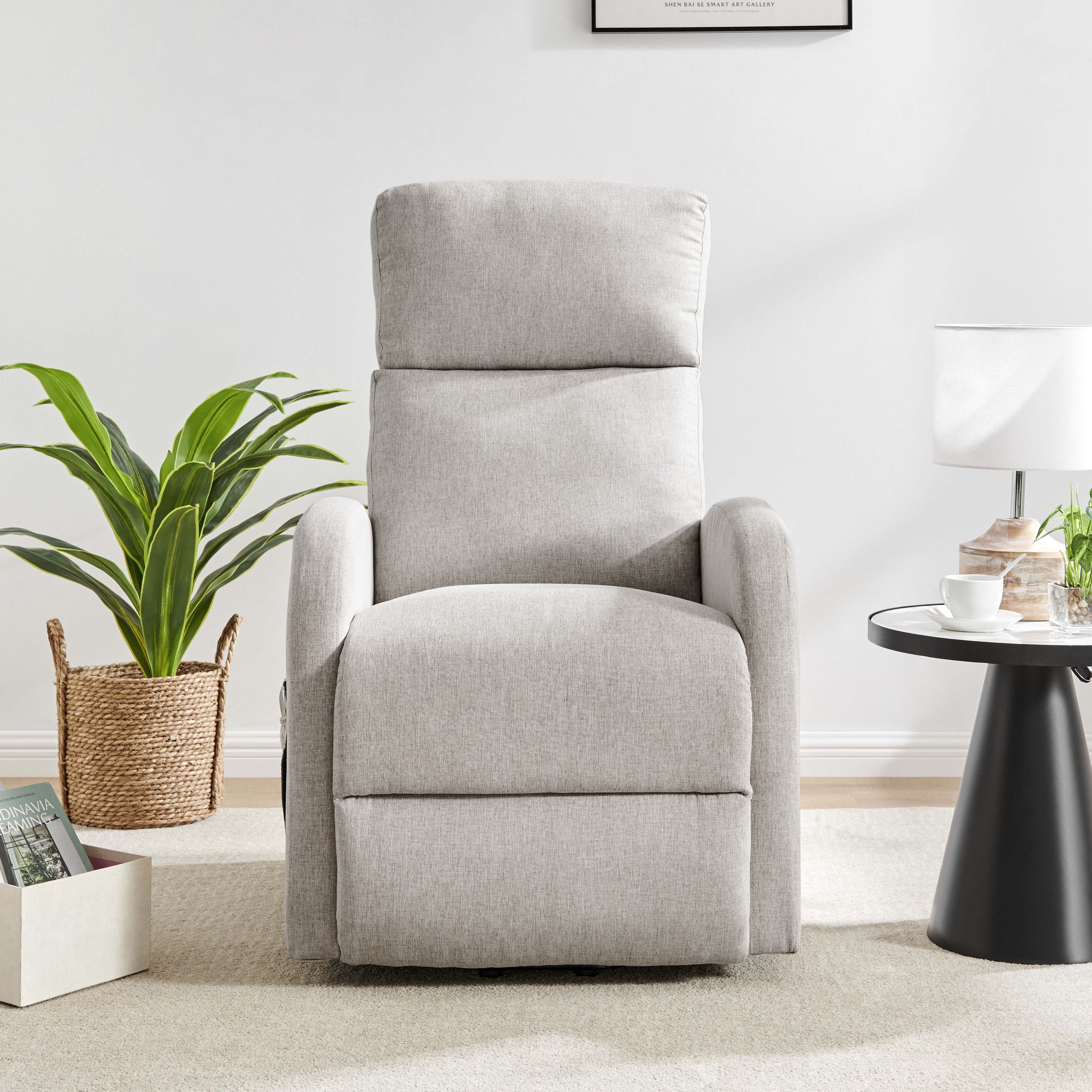 A cream-colored Barker Lift & Tilt recliner chair with plush cushions, situated in a room with a side table and a plant.