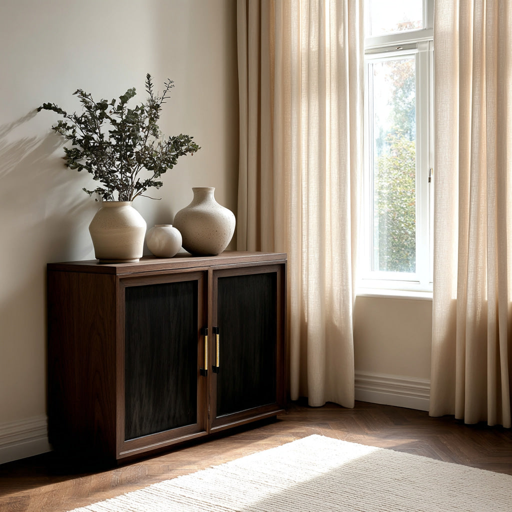Wooden sideboard with decorative vases and plants in a room with a window and curtains.