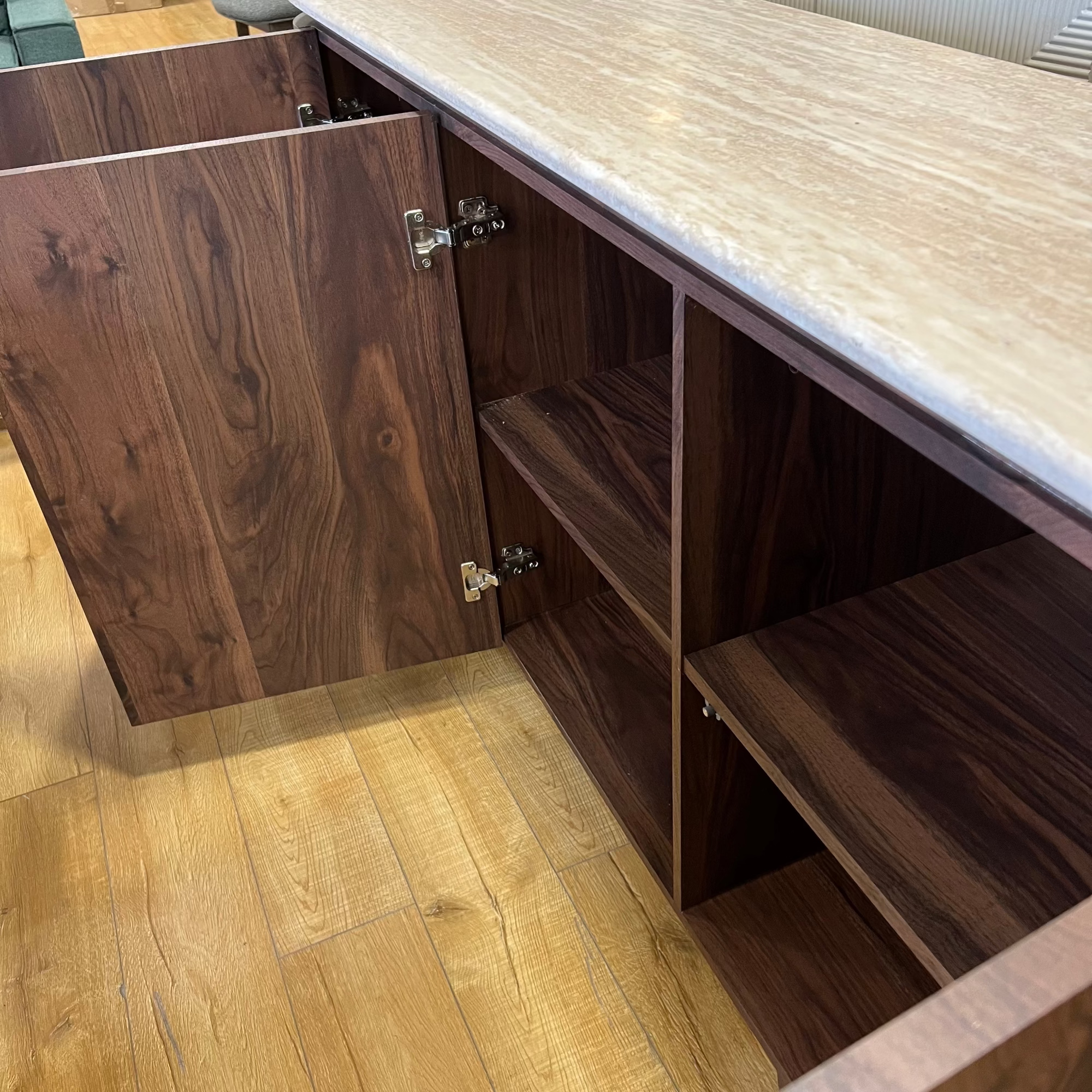 Wooden cabinet with open doors on a wooden floor