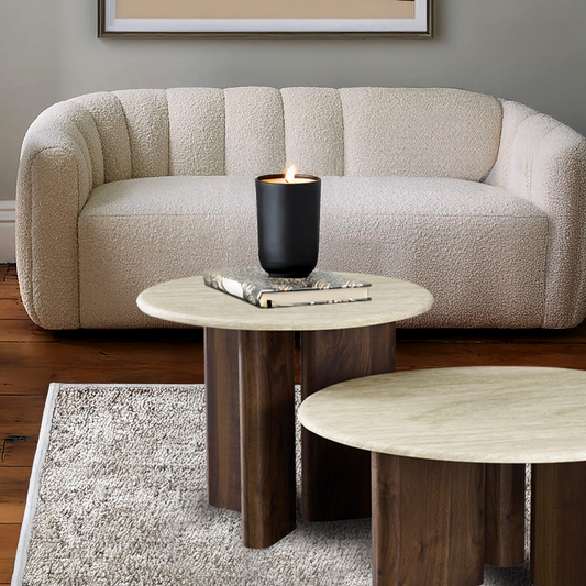 Beige sofa with a wooden coffee table and candle in a living room setting.