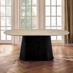 Modern dining table with a black base in a room with large windows and wooden flooring.