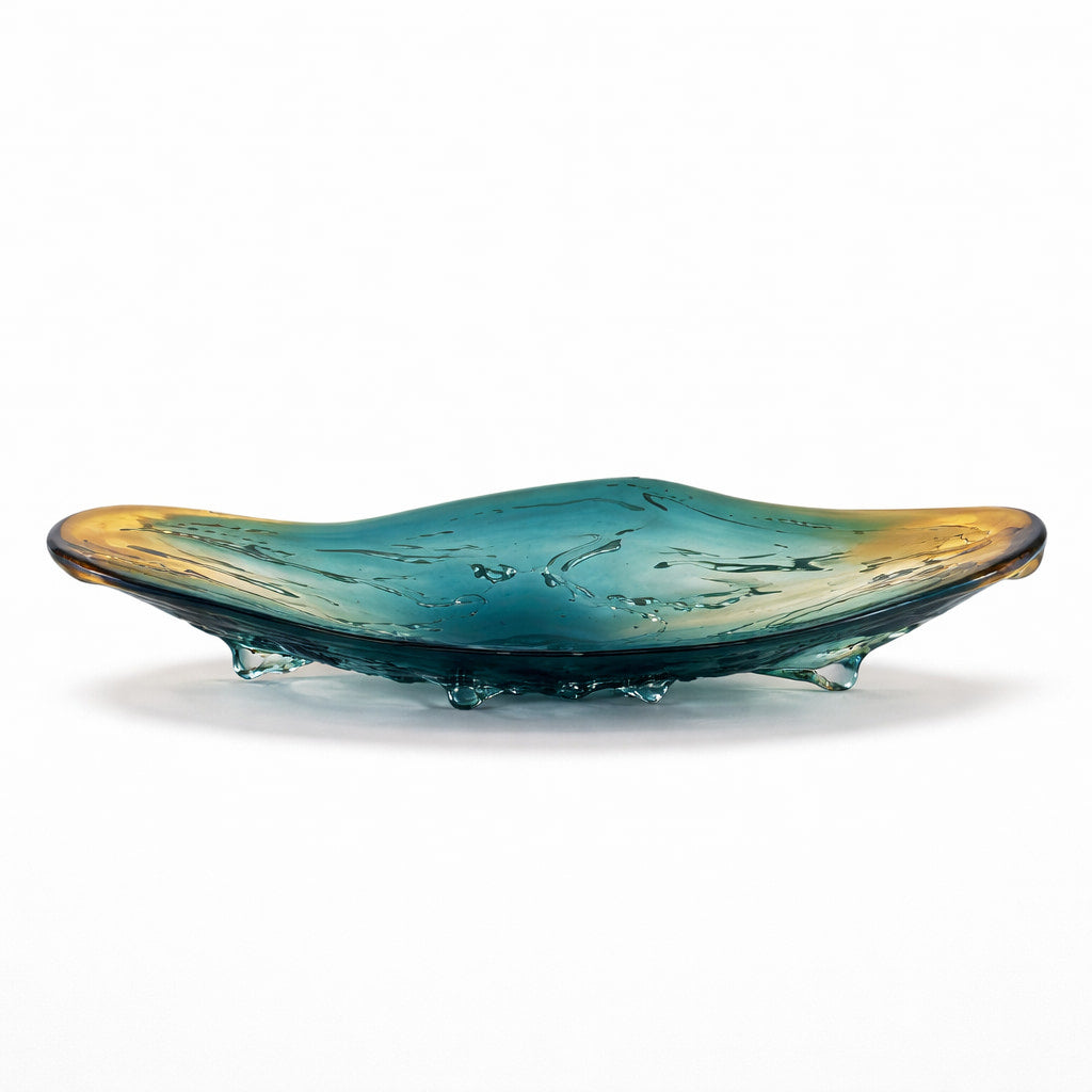 Glass dish with teal and gold gradient on a white background