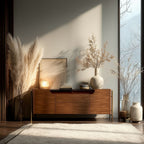 Wooden sideboard with decorative items in a room with large windows.
